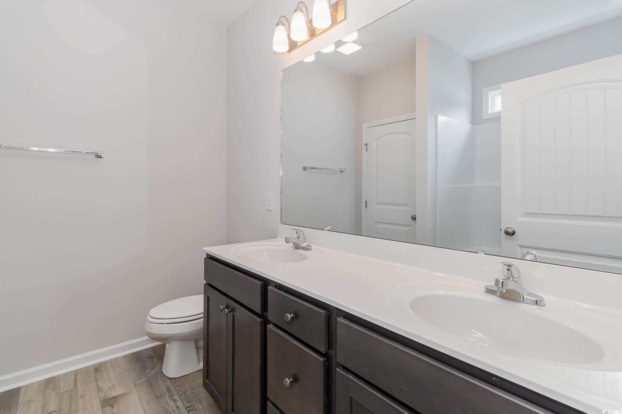 323 Lakota Loop Longs, SC 29568 - Photo 12 of 19 Bathroom with dual vanity, toilet, and hardwood /