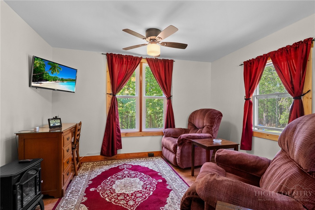 154 Folger Road Sparta, NC 28675 - Photo 8 of 37 a living room with furniture a flat screen tv and a large window