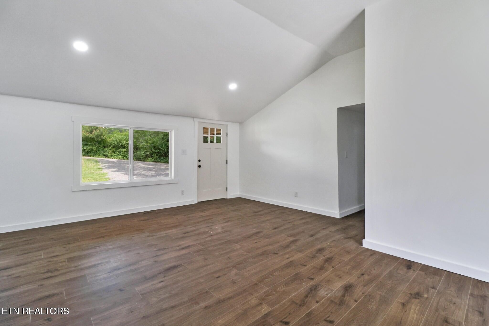 1095 Franklin Road Jamestown, TN 38556 - Photo 13 of 31 an empty room with wooden floor and windows