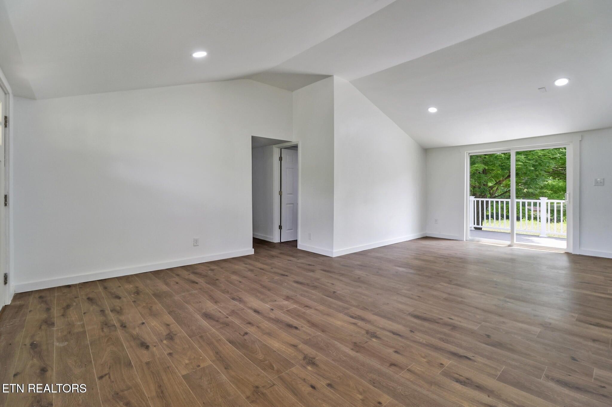 1095 Franklin Road Jamestown, TN 38556 - Photo 14 of 31 a view of an empty room with wooden floor and a window