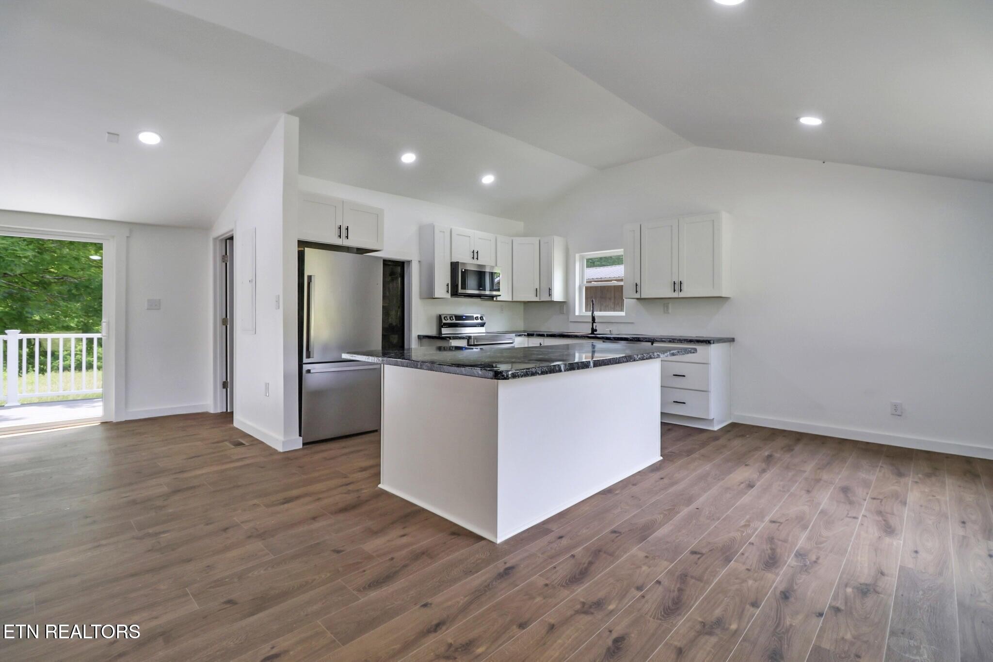 1095 Franklin Road Jamestown, TN 38556 - Photo 16 of 31 a kitchen with stainless steel appliances granite countertop a refrigerator a stove a sink and a microwave