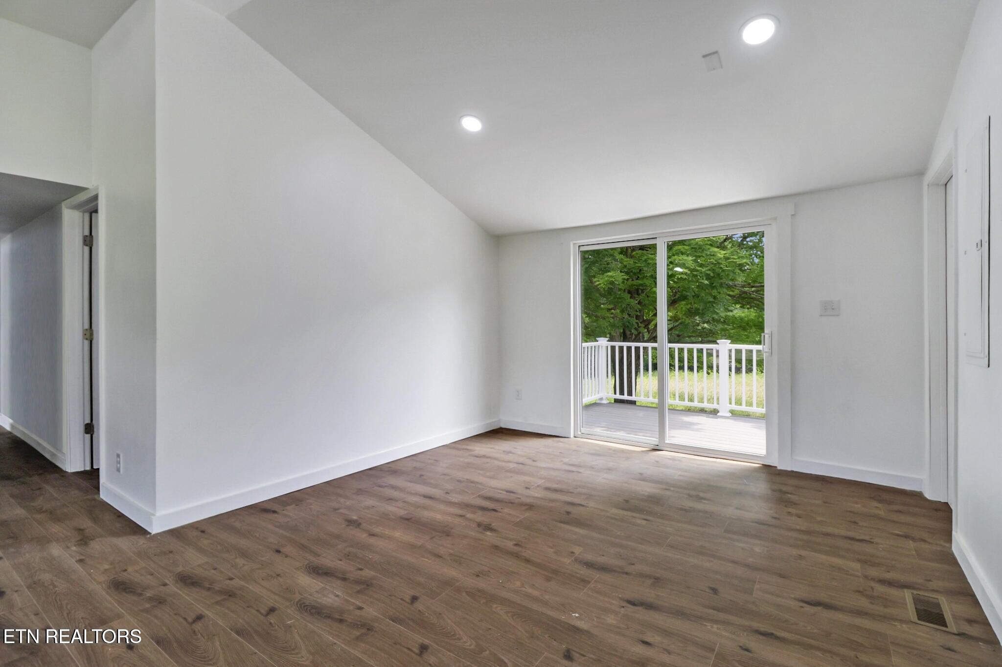 1095 Franklin Road Jamestown, TN 38556 - Photo 20 of 31 a view of an empty room with wooden floor and a window