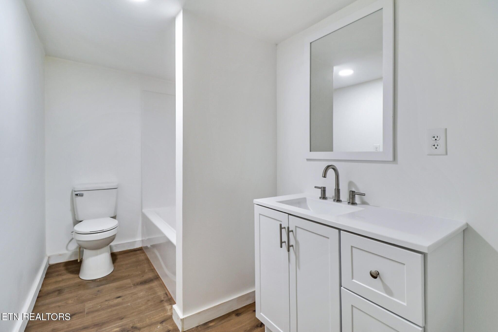 1095 Franklin Road Jamestown, TN 38556 - Photo 22 of 31 a bathroom with a sink toilet and a mirror