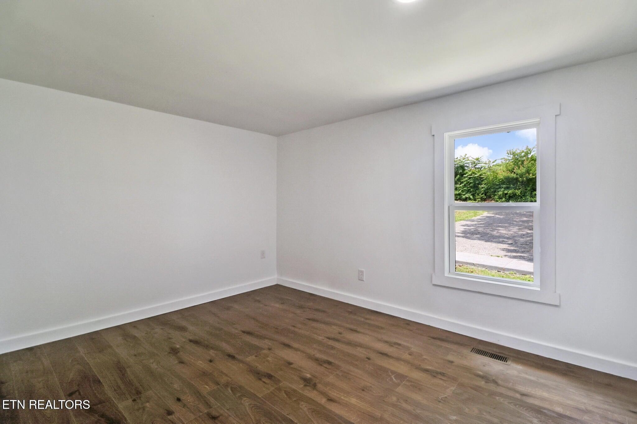1095 Franklin Road Jamestown, TN 38556 - Photo 23 of 31 wooden floor in an empty room with a window