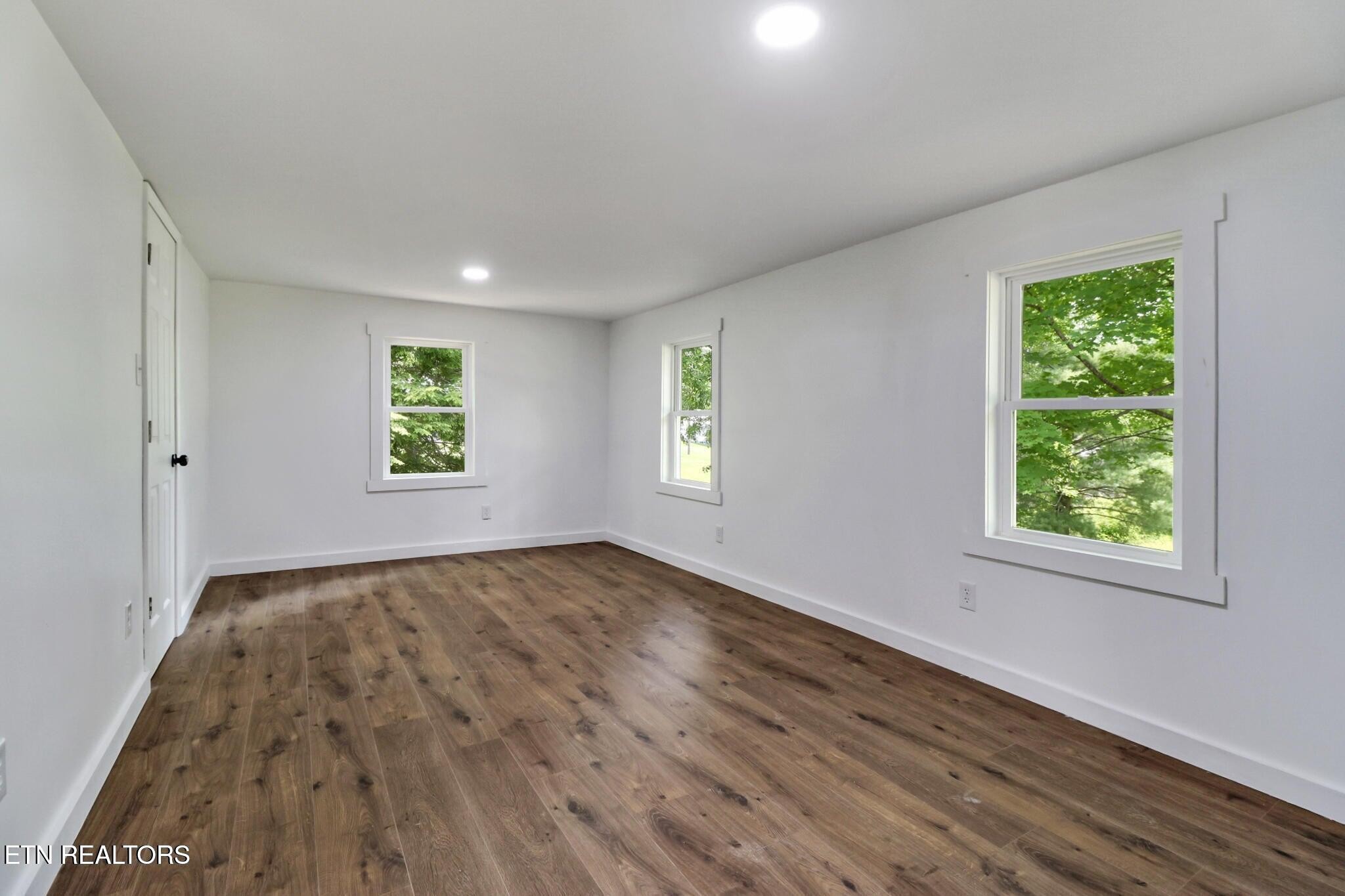 1095 Franklin Road Jamestown, TN 38556 - Photo 25 of 31 wooden floor in an empty room with a window