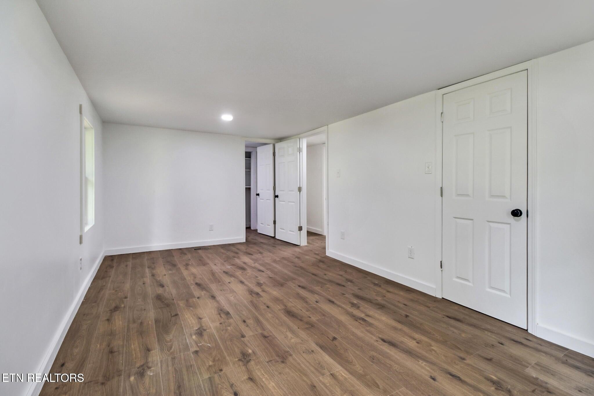 1095 Franklin Road Jamestown, TN 38556 - Photo 26 of 31 a view of an empty room with wooden floor
