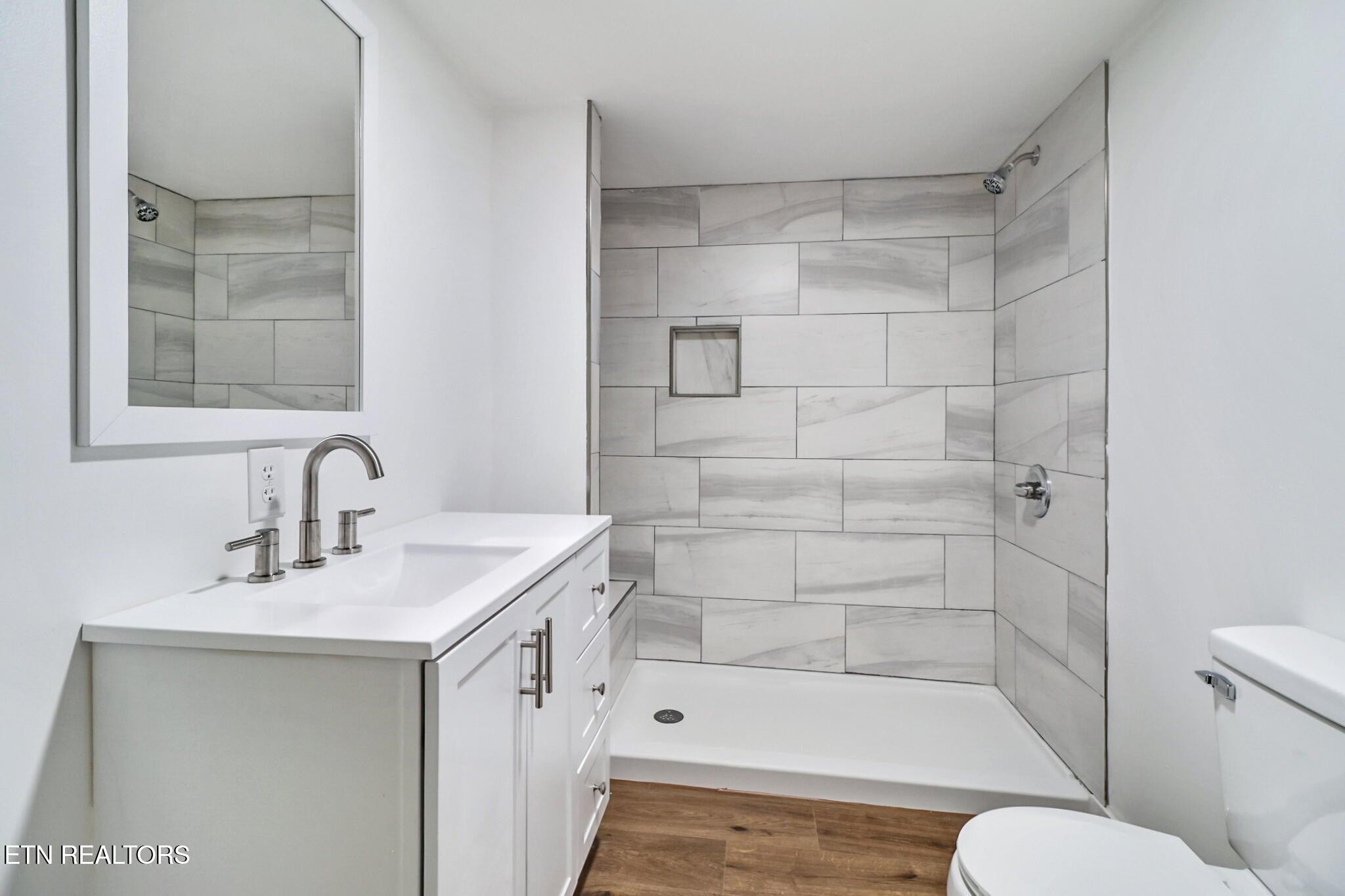 1095 Franklin Road Jamestown, TN 38556 - Photo 27 of 31 a bathroom with a bathtub shower sink vanity and toilet