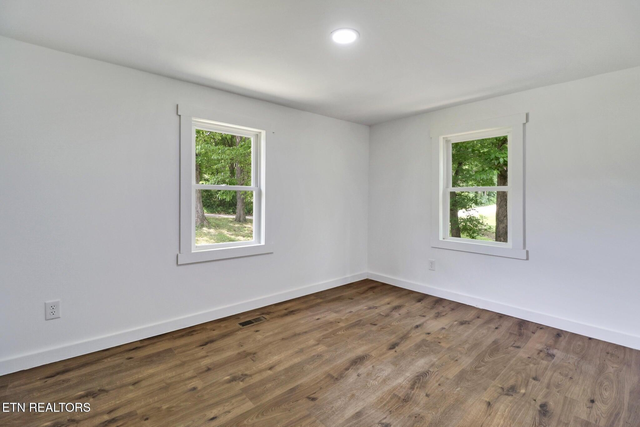 1095 Franklin Road Jamestown, TN 38556 - Photo 28 of 31 a view of an empty room with wooden floor and a window