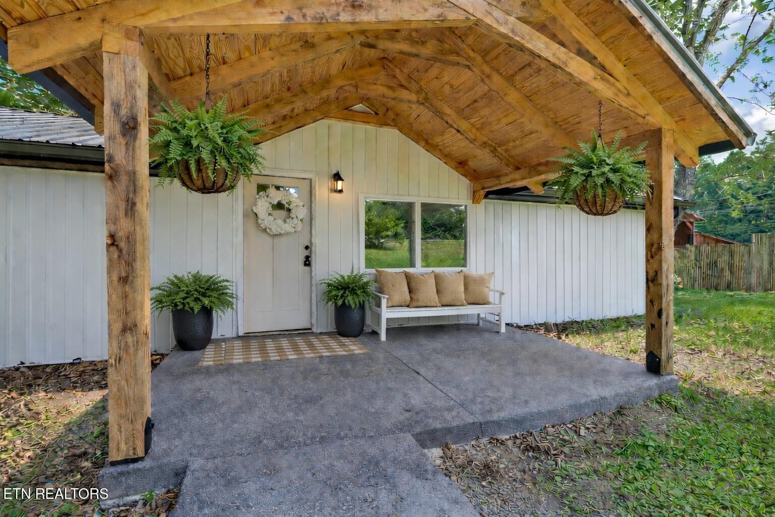 1095 Franklin Road Jamestown, TN 38556 - Photo 3 of 31 a backyard of a house with plants and outdoor seating