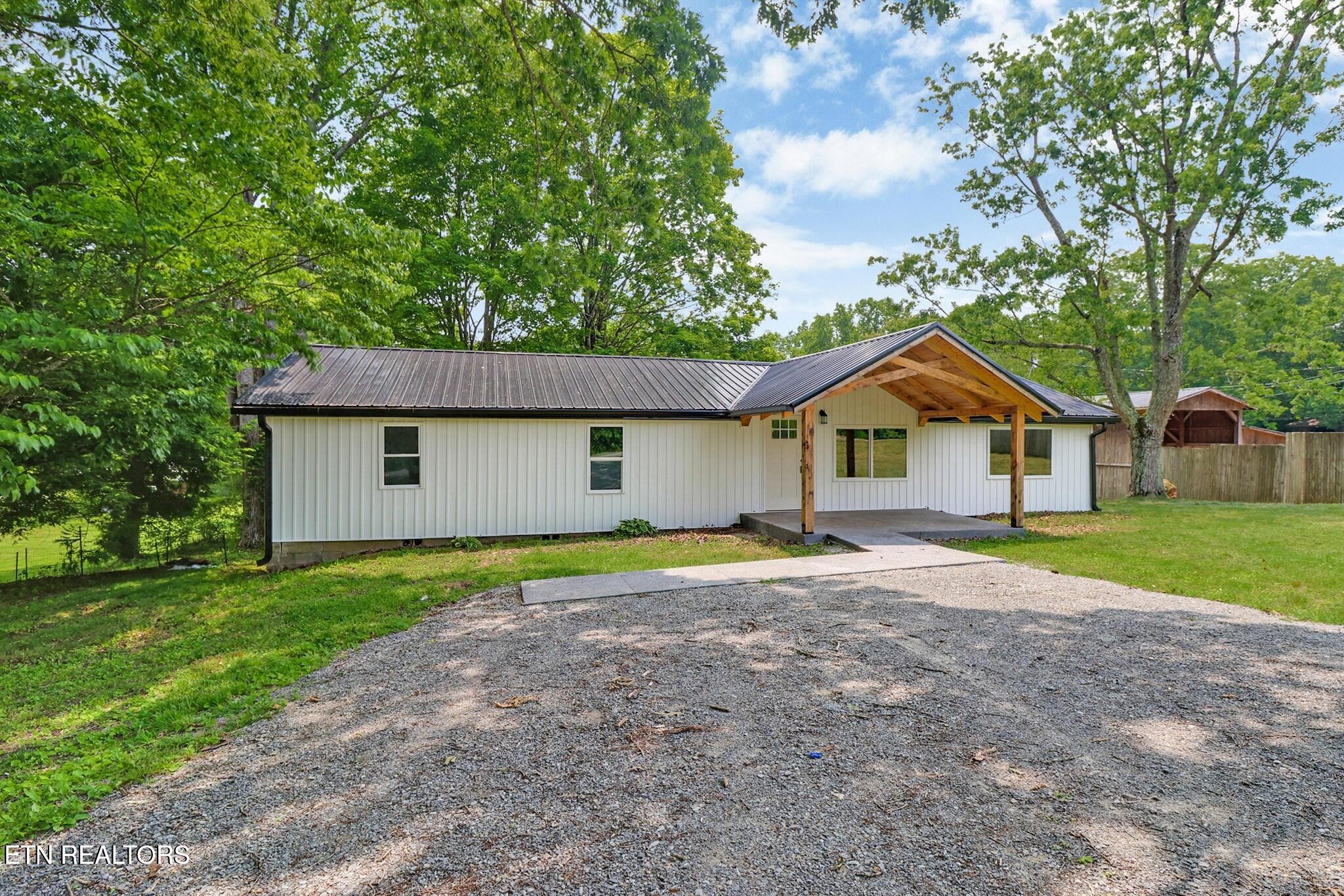 1095 Franklin Road Jamestown, TN 38556 - Photo 6 of 31 a front view of house with yard and trees in the background