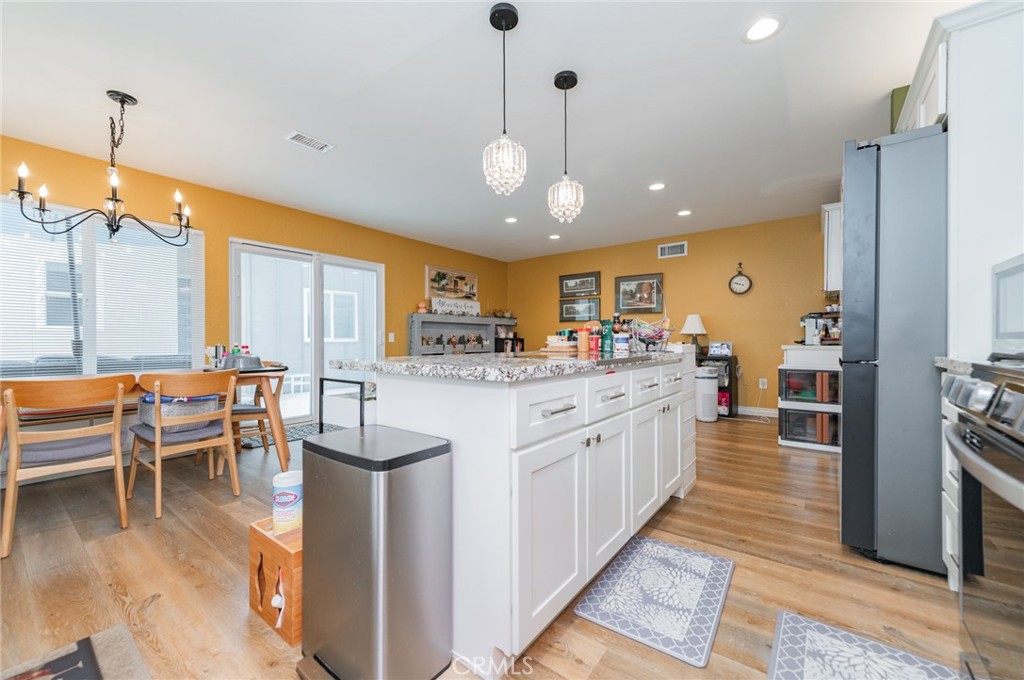 23 Country Ridge Road Phillips Ranch, CA 91766 - Photo 12 of 45 a large kitchen with granite countertop lots of counter space dining table and stainless steel appliances