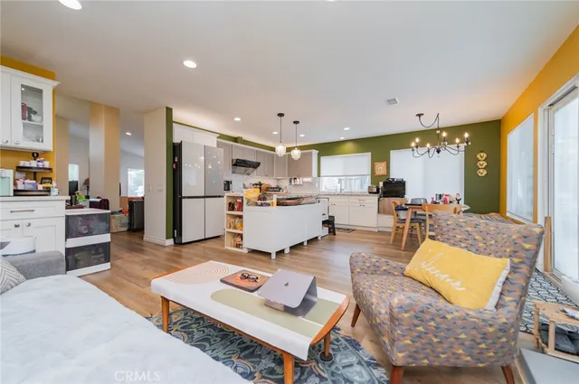 a living room with furniture and kitchen view