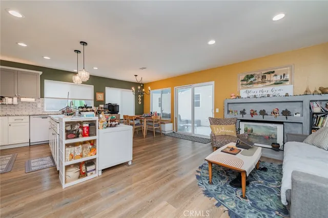 a living room with furniture and kitchen view