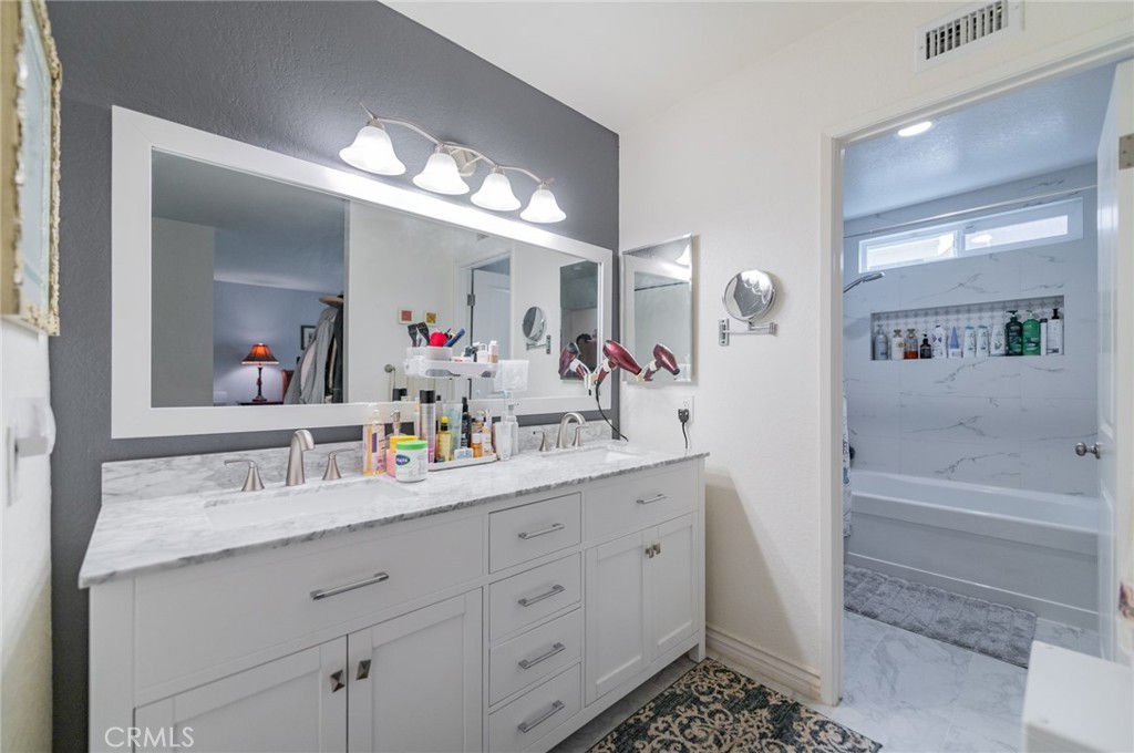 23 Country Ridge Road Phillips Ranch, CA 91766 - Photo 19 of 45 a bathroom with a sink a vanity and a mirror