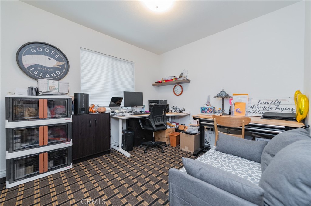 23 Country Ridge Road Phillips Ranch, CA 91766 - Photo 22 of 45 a living room with a couch and a clock on a bookshelf