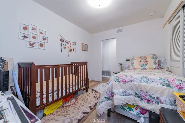a bedroom with bed and baby crib