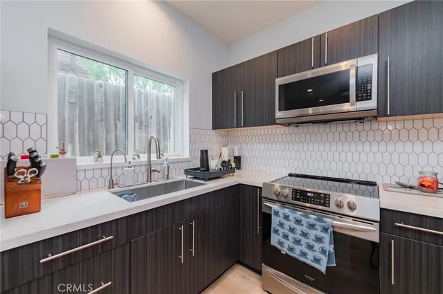 a kitchen with a sink stove and microwave