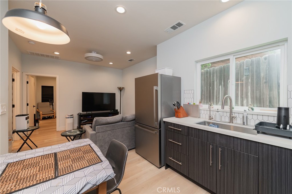 23 Country Ridge Road Phillips Ranch, CA 91766 - Photo 29 of 45 a view of a kitchen with a sink furniture and a flat screen tv