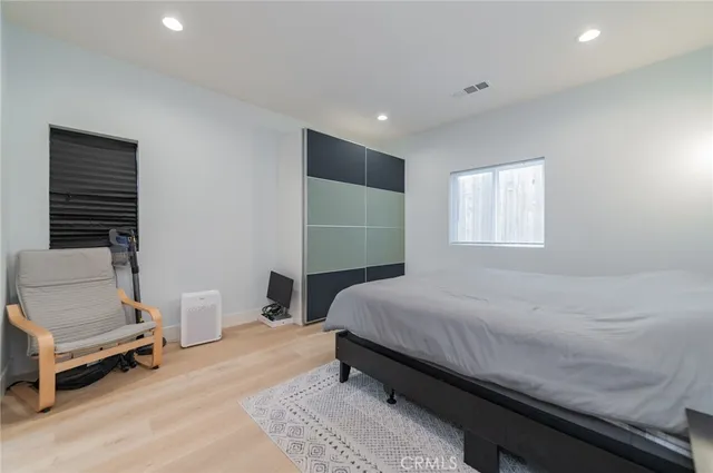 a bedroom with a bed and a chair