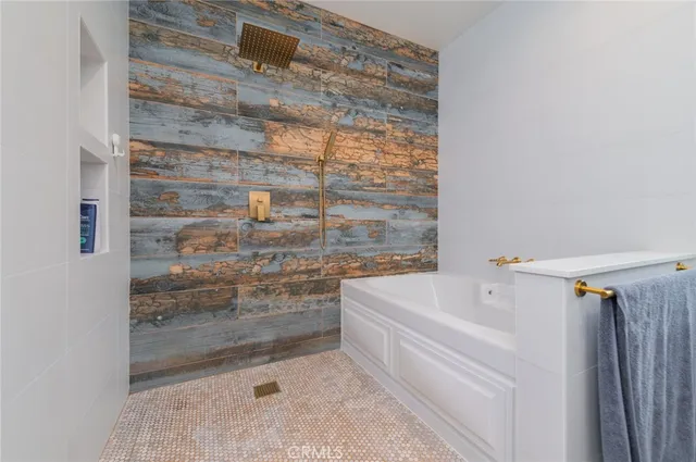 a bathroom with a bathtub and a shower