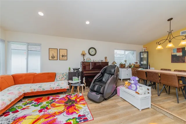 a living room with lots of furniture and a lamp