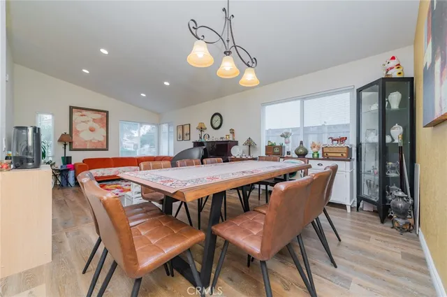 a dining hall with a dining table and chairs with wooden floor