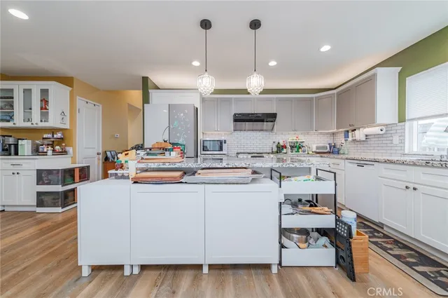 a kitchen with cabinets a sink and appliances