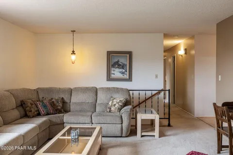 a living room with furniture and a ceiling fan