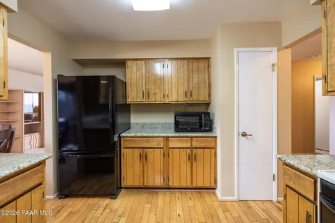 a kitchen with granite countertop a refrigerator and a stove