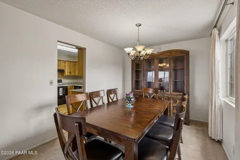 a view of a dining room with furniture and chandelier