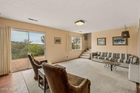 a living room with furniture and a floor to ceiling window