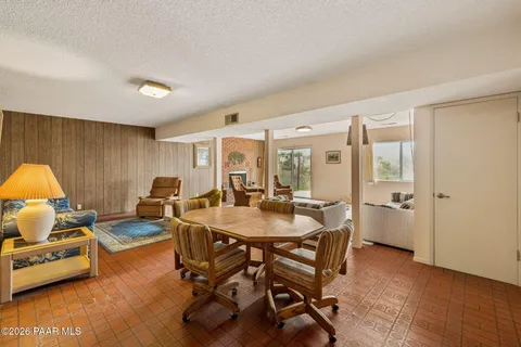 a view of a livingroom with furniture and a table in it