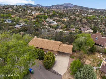 an aerial view of a house with a yard