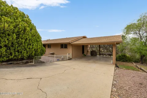 a view of a house with a patio and a yard