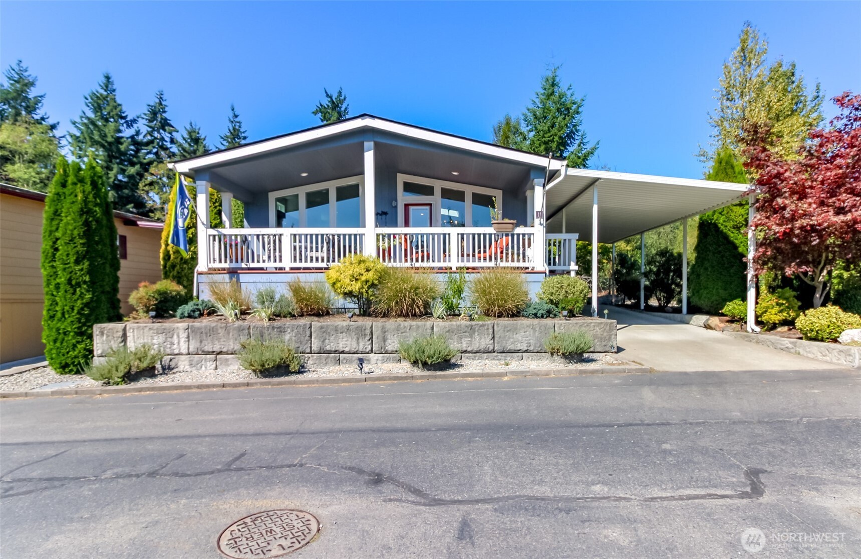 2101 South 324th Street, Unit 11 Federal Way, WA 98003 - Photo 5 of 40 a front view of a house with a yard and potted plants
