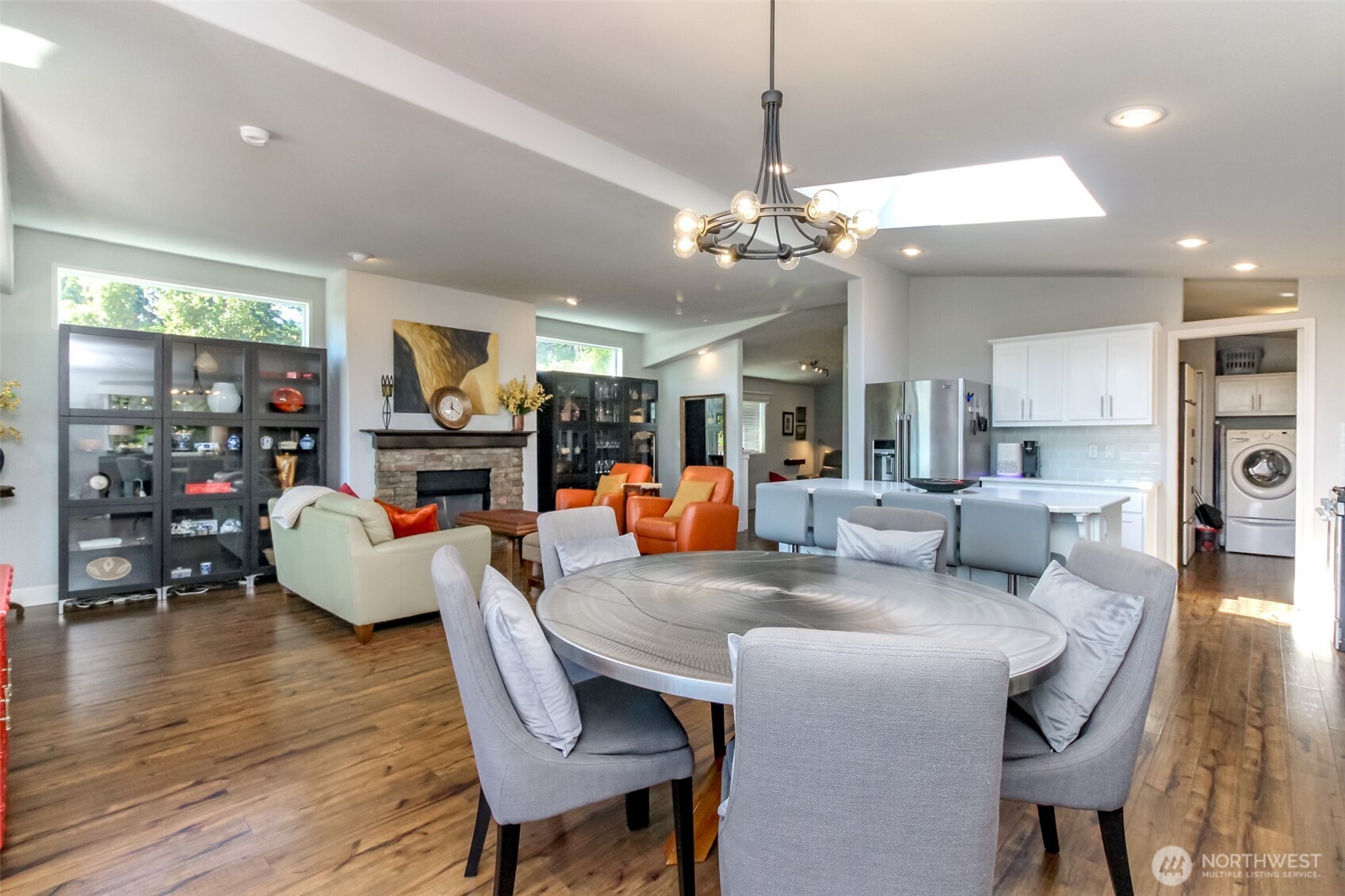 2101 South 324th Street, Unit 11 Federal Way, WA 98003 - Photo 6 of 40 a view of a dining room and livingroom with furniture wooden floor a chandelier