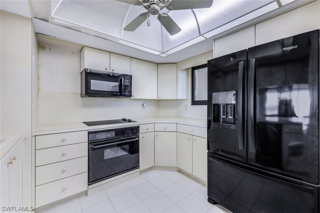 15021 Punta Rassa Road, Unit 504 Fort Myers, FL 33908 - Photo 12 of 24 a kitchen with stainless steel appliances and chandelier
