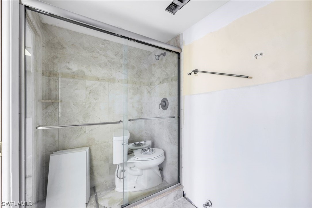 15021 Punta Rassa Road, Unit 504 Fort Myers, FL 33908 - Photo 17 of 24 a bathroom with a shower and a toilet