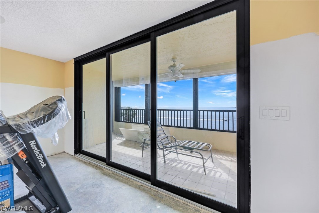 15021 Punta Rassa Road, Unit 504 Fort Myers, FL 33908 - Photo 9 of 24 a view of a porch with a floor to ceiling window