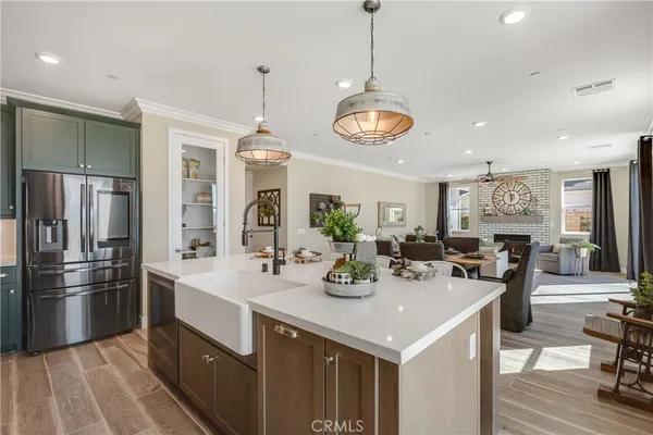a view of a dining room with furniture a chandelier and wooden floor
