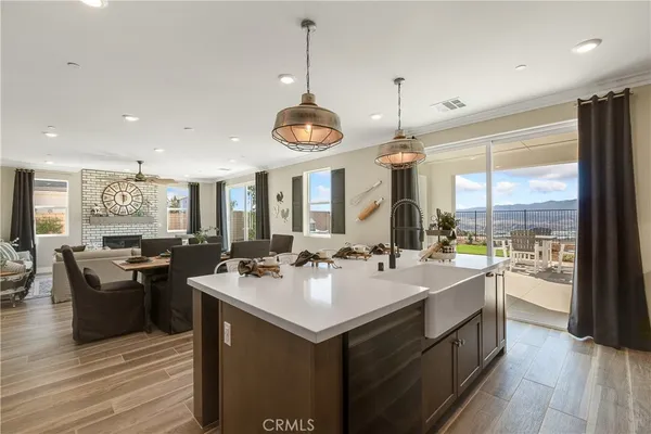 a kitchen with a stove a sink and a wooden floor
