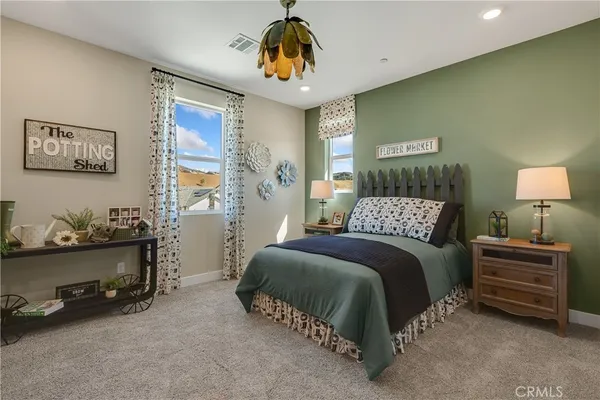a view of kitchen with kitchen island stainless steel appliances refrigerator stove dining table and chairs