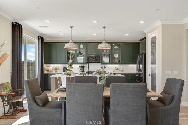 a living room with furniture a fireplace and large windows