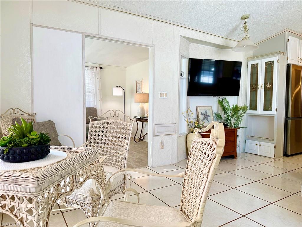 233 Cattleya Refuge, Unit 233 Naples, FL 34114 - Photo 11 of 48 a bedroom with a bed and a television