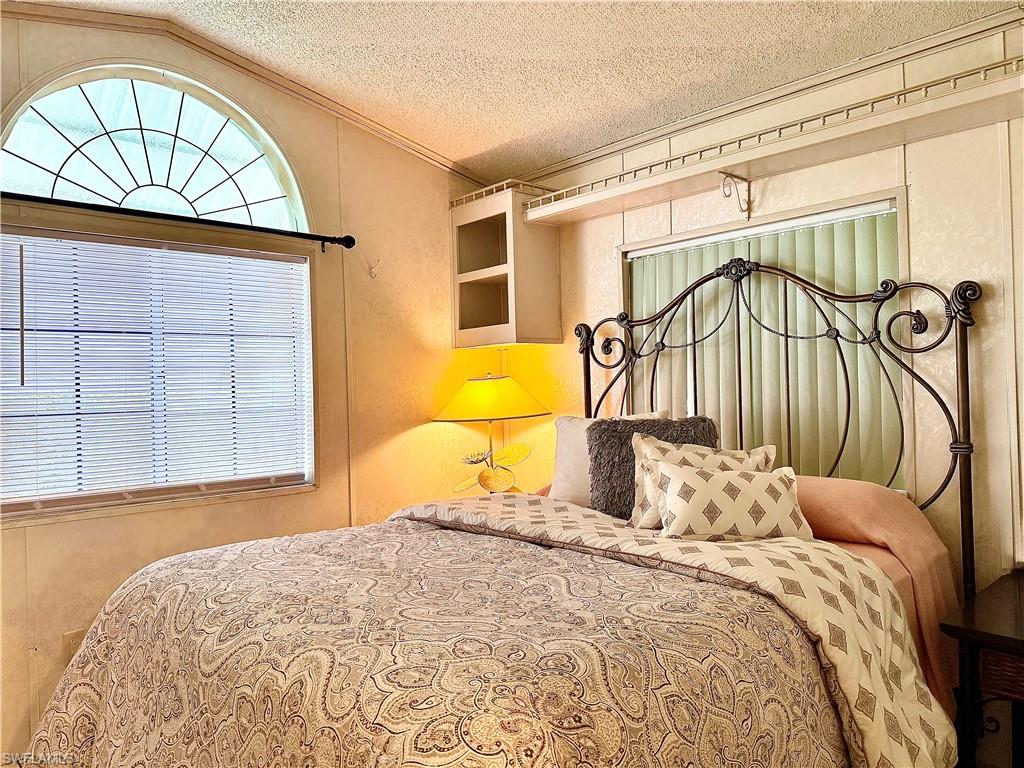 233 Cattleya Refuge, Unit 233 Naples, FL 34114 - Photo 15 of 48 a bedroom with a bed and a window