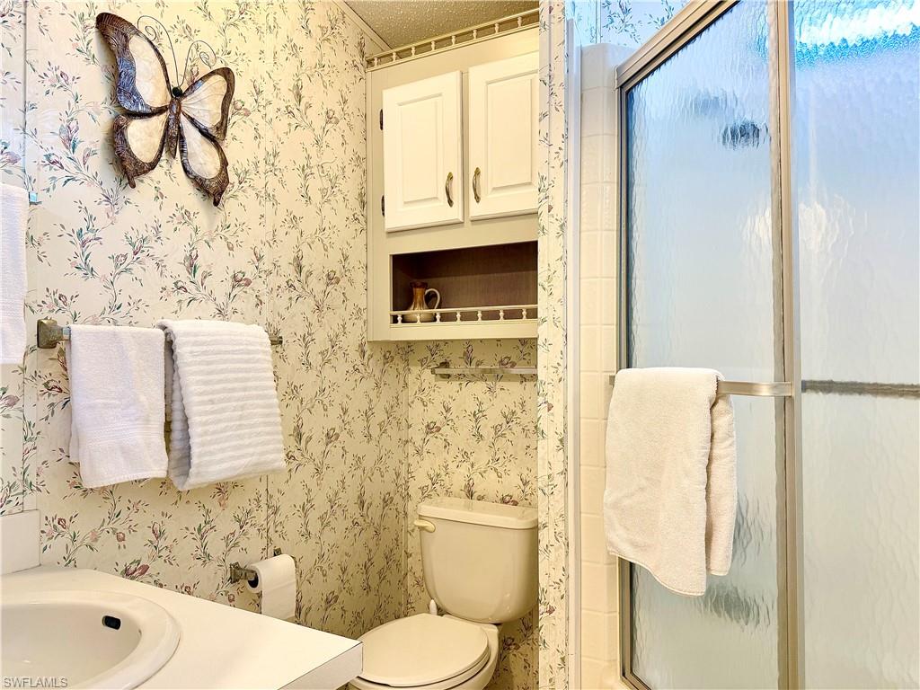 233 Cattleya Refuge, Unit 233 Naples, FL 34114 - Photo 17 of 48 a bathroom with a toilet sink and shower