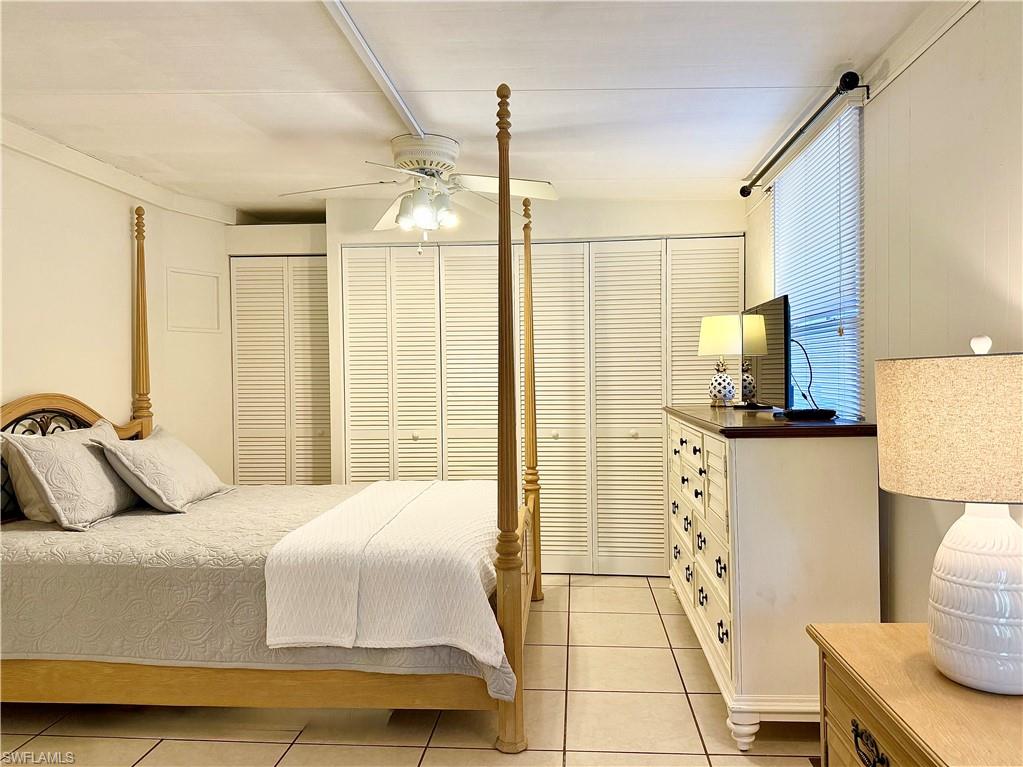 233 Cattleya Refuge, Unit 233 Naples, FL 34114 - Photo 21 of 48 a bedroom with a bed and a couch