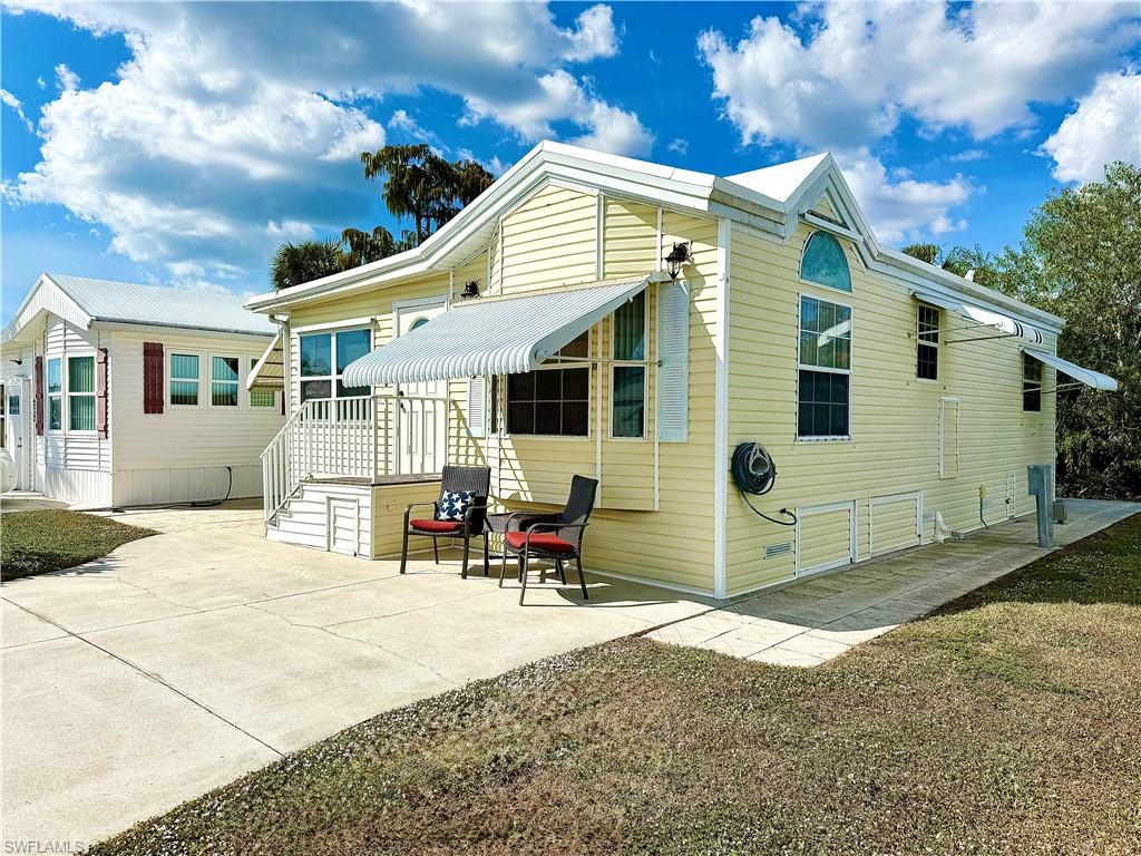 233 Cattleya Refuge, Unit 233 Naples, FL 34114 - Photo 27 of 48 a backyard of a house with yard and outdoor seating