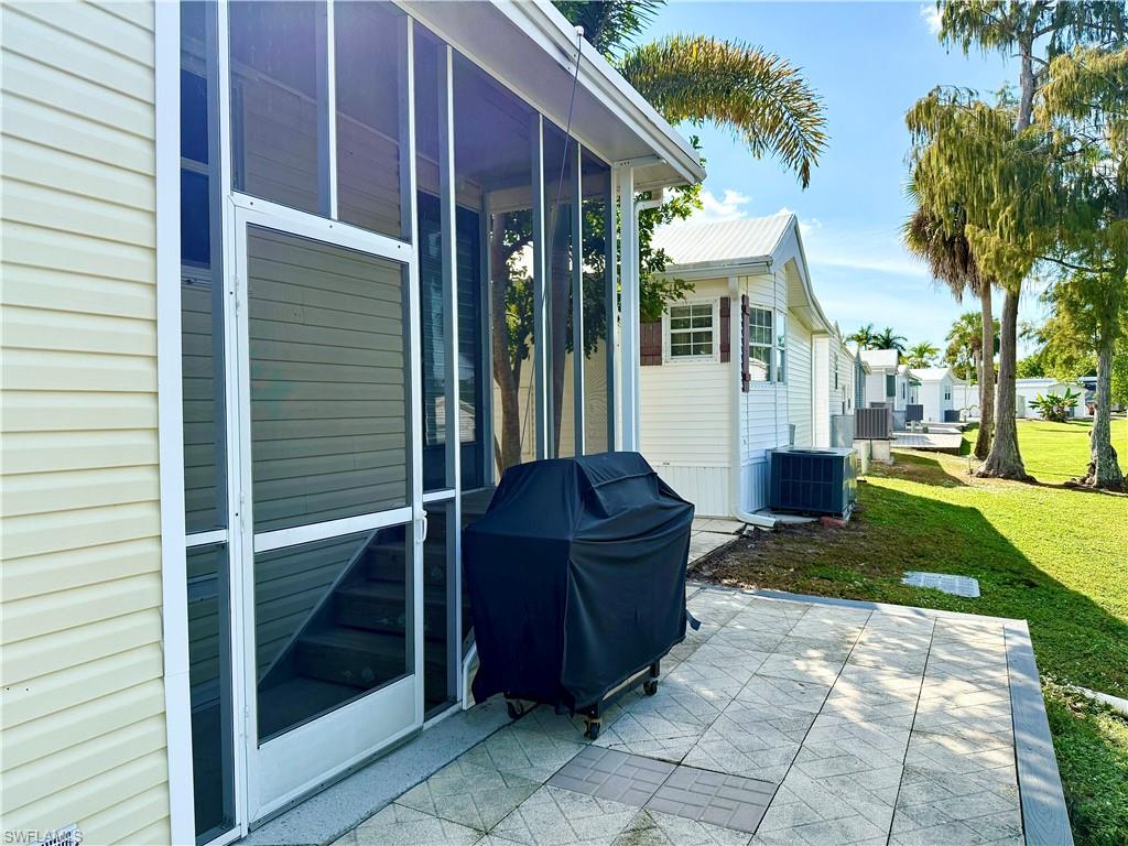 233 Cattleya Refuge, Unit 233 Naples, FL 34114 - Photo 5 of 48 a view of a porch with furniture and a yard