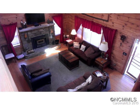 2406 Hemphill Road Waynesville, NC 28785 - Photo 6 of 19 a kitchen living room with furniture a fireplace and a flat screen tv